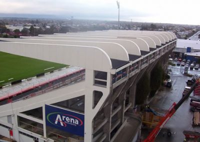 Aerial view of the curved roof and seating of the Arena Manawatu main grandstand