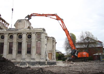 Excavator and crane removing masonry from the Cathedral of the Blessed Sacrament