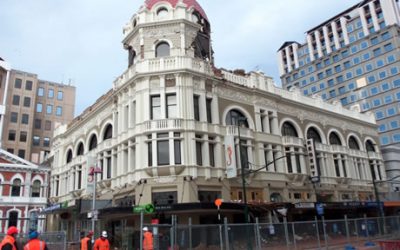 The heritage-listed Regent Buildings in Christchurch with its domed corner tower, cordoned off before deconstruction