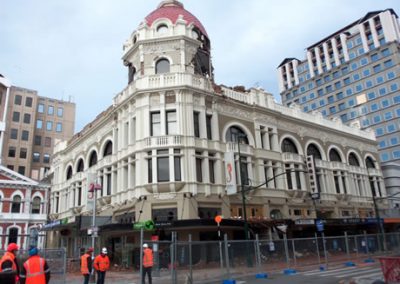 The heritage-listed Regent Buildings in Christchurch with its domed corner tower, cordoned off before deconstruction