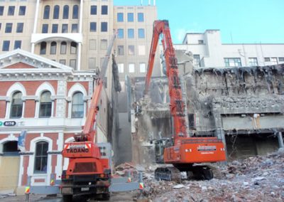 Excavator and crane working on the stripped rear structure of the Regent Buildings