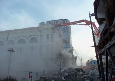 Dust rising as the high reach excavator works on the Regent Buildings facade