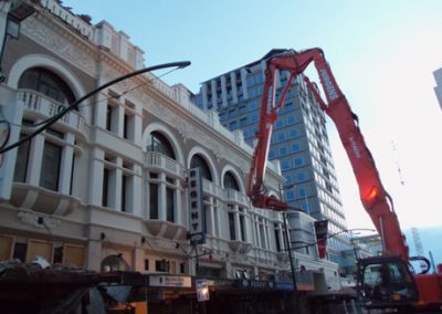 High reach excavator working above the ornate Regent Buildings facade