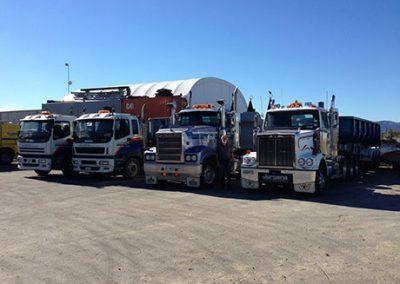 Line-up of Jurgens heavy haulage trucks and tippers parked in the depot yard