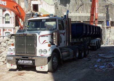 Jurgens truck and bin trailer loading demolition debris on an inner-city site